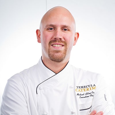 Chef with white uniform smiling